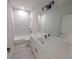 Clean bathroom boasts a tub, sink, vanity, and mirror at 7330 Printer St, Port Charlotte, FL 33981