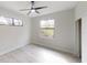Serene bedroom featuring a large window and tile floors, providing a comfortable and relaxing atmosphere at 7330 Printer St, Port Charlotte, FL 33981
