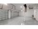A large garage features large doors, epoxy floors and a pull down ladder to the attic at 7330 Printer St, Port Charlotte, FL 33981