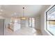 Bright open-concept kitchen with stainless steel appliances, quartz countertops, and breakfast bar seating at 7330 Printer St, Port Charlotte, FL 33981