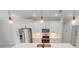 Modern kitchen featuring stainless steel appliances, white cabinets, quartz countertops, and pendant lighting at 7330 Printer St, Port Charlotte, FL 33981