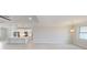 Bright, open-concept living space with modern lighting, wood floors, and easy access to the kitchen at 7330 Printer St, Port Charlotte, FL 33981