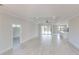 Bright, open-concept living space featuring wood floors, modern ceiling fan, and sliding glass doors to the lanai at 7330 Printer St, Port Charlotte, FL 33981