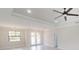 Bright living room featuring wood floors, elegant lighting, and a view of the outdoor through the double doors at 7330 Printer St, Port Charlotte, FL 33981