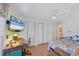 Bedroom featuring a work desk, a large closet, and mounted television at 735 Summersea Ct, Englewood, FL 34223