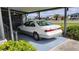 Carport featuring a covered parking space with fan and nearby landscape at 735 Summersea Ct, Englewood, FL 34223