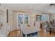 Dining room with a white table, doors to the patio, and a stylish chandelier at 735 Summersea Ct, Englewood, FL 34223