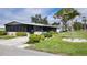 Charming single-story home featuring a screened porch, carport, and well-maintained landscaping at 735 Summersea Ct, Englewood, FL 34223