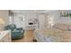 Comfortable bedroom with a queen bed, side tables, work desk, and bright lighting at 735 Summersea Ct, Englewood, FL 34223