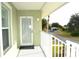 Condo balcony with white railing overlooking a paved pathway and carport at 8100 Memory Ln # 207, Rotonda West, FL 33947
