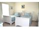 Bright bedroom with twin beds, light blue bedding, and ample natural light at 8100 Memory Ln # 207, Rotonda West, FL 33947