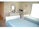 Bedroom with white dresser, twin beds, and light blue bedding at 8100 Memory Ln # 207, Rotonda West, FL 33947