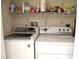 Laundry room with washer, dryer, and shelving for storage at 8100 Memory Ln # 207, Rotonda West, FL 33947