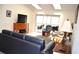 Living room features a TV, sliding doors to a balcony, and ample natural light at 8100 Memory Ln # 207, Rotonda West, FL 33947