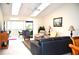 Living room with seating area and sliding glass doors to balcony at 8100 Memory Ln # 207, Rotonda West, FL 33947