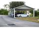 Covered parking area with several cars parked under shelter at 8100 Memory Ln # 207, Rotonda West, FL 33947