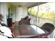 Screened porch with table and chairs, perfect for outdoor dining at 8100 Memory Ln # 207, Rotonda West, FL 33947