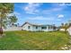 Light blue house with a large grassy backyard and a white fence at 833 Harbor S Dr, Venice, FL 34285