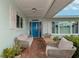 Inviting front porch with blue door and comfortable seating at 833 Harbor S Dr, Venice, FL 34285