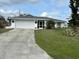 Single-story home with a two-car garage and well-maintained lawn at 872 Dobell Nw Ter, Port Charlotte, FL 33948