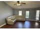 Living room featuring a cream sectional, tile flooring, and bright natural light at 872 Dobell Nw Ter, Port Charlotte, FL 33948