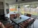 Spacious screened porch with patio furniture, perfect for relaxing outdoors at 872 Dobell Nw Ter, Port Charlotte, FL 33948