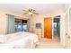 Bright bedroom with sliding glass doors leading to a balcony at 10 Quails Run Blvd # 12, Englewood, FL 34223