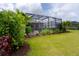 Landscaped backyard with a screened pool and patio at 10958 Trevino St, Englewood, FL 34223