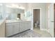 Elegant bathroom with double vanity and separate toilet at 10958 Trevino St, Englewood, FL 34223