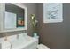 Modern bathroom with white vanity, a frameless mirror, and succulents at 10958 Trevino St, Englewood, FL 34223