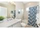Clean bathroom with tub shower, and patterned curtain at 10958 Trevino St, Englewood, FL 34223