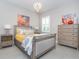 Guest bedroom with a queen bed and neutral decor at 10958 Trevino St, Englewood, FL 34223