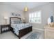 Cozy bedroom with a queen bed and blue color scheme at 10958 Trevino St, Englewood, FL 34223
