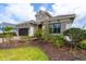 Two-story home with gray exterior and lush landscaping at 10958 Trevino St, Englewood, FL 34223