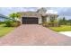Beautiful home with a brick driveway and landscaping at 10958 Trevino St, Englewood, FL 34223