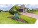Landscaped front yard with brick pavers and lush greenery at 10958 Trevino St, Englewood, FL 34223