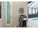 Outdoor kitchen with built-in gas grill near the pool at 10958 Trevino St, Englewood, FL 34223