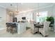 Spacious kitchen with white cabinets, quartz countertops, and stainless steel appliances at 10958 Trevino St, Englewood, FL 34223