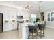 Bright and airy kitchen with white cabinets and a large island at 10958 Trevino St, Englewood, FL 34223