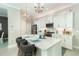 Kitchen island with white cabinets and quartz countertops at 10958 Trevino St, Englewood, FL 34223