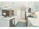 Bright kitchen features an island, stainless steel appliances, and white cabinets at 10958 Trevino St, Englewood, FL 34223