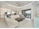 Spacious living room with coffered ceiling, and view of pool at 10958 Trevino St, Englewood, FL 34223