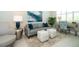 Cozy sitting area with gray sofa, patterned rug & natural light at 10958 Trevino St, Englewood, FL 34223