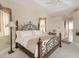A well-lit bedroom featuring a decorative wrought iron bed frame and neutral decor at 110 Barracuda Dr, Placida, FL 33946