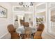 Dining room with wicker chairs and a glass top table, open to the kitchen and living room at 110 Barracuda Dr, Placida, FL 33946