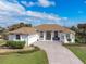 Charming home with manicured lawn, concrete driveway, and elegant entryway at 110 Barracuda Dr, Placida, FL 33946