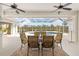 Covered outdoor pool area with patio seating, ceiling fans, and views of surrounding greenery at 110 Barracuda Dr, Placida, FL 33946