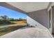 Covered back patio with serene backyard views at 119 White Pine Dr, Rotonda West, FL 33947