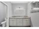 Bathroom with a double vanity, a granite countertop, and a glass-enclosed shower at 119 White Pine Dr, Rotonda West, FL 33947