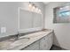 Bright bathroom featuring a double vanity with granite countertop at 119 White Pine Dr, Rotonda West, FL 33947